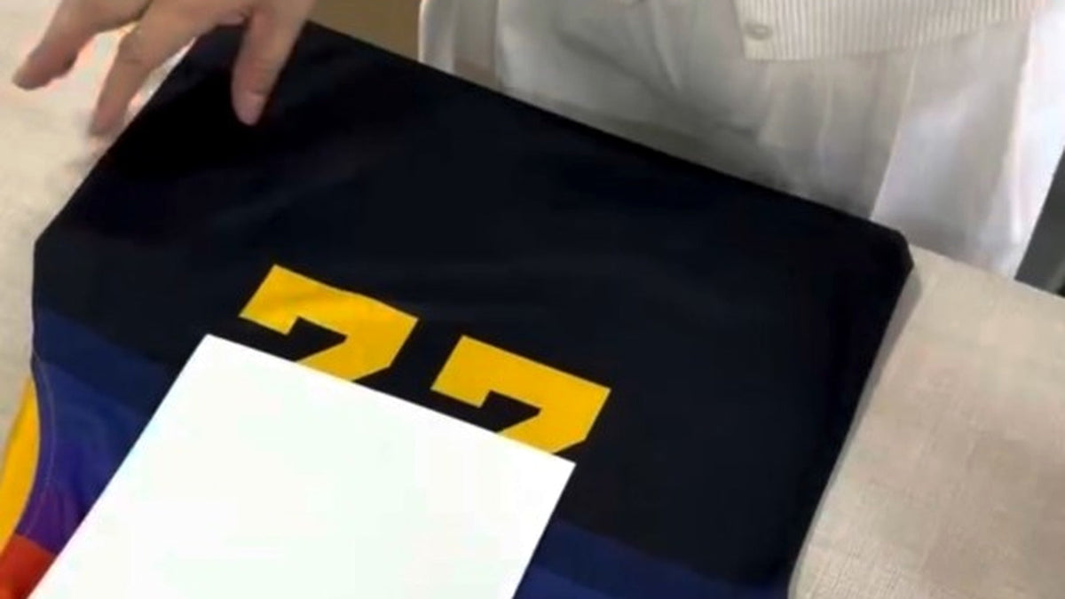 A custom teamwear jersey being packed for dispatch